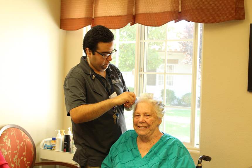 Resident with hair stylist