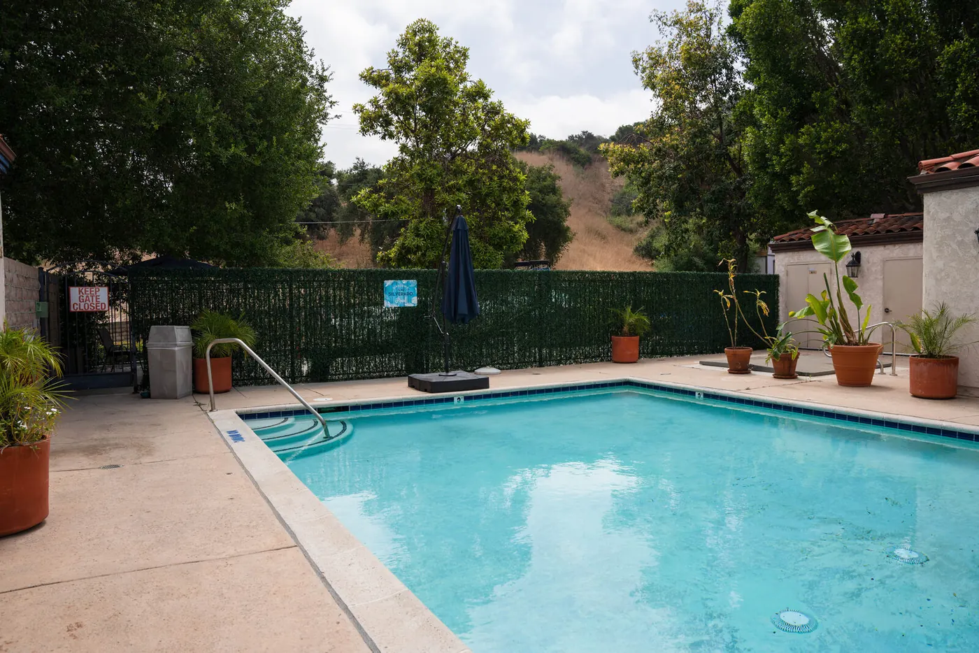 The outdoor pool and shaded patio seating