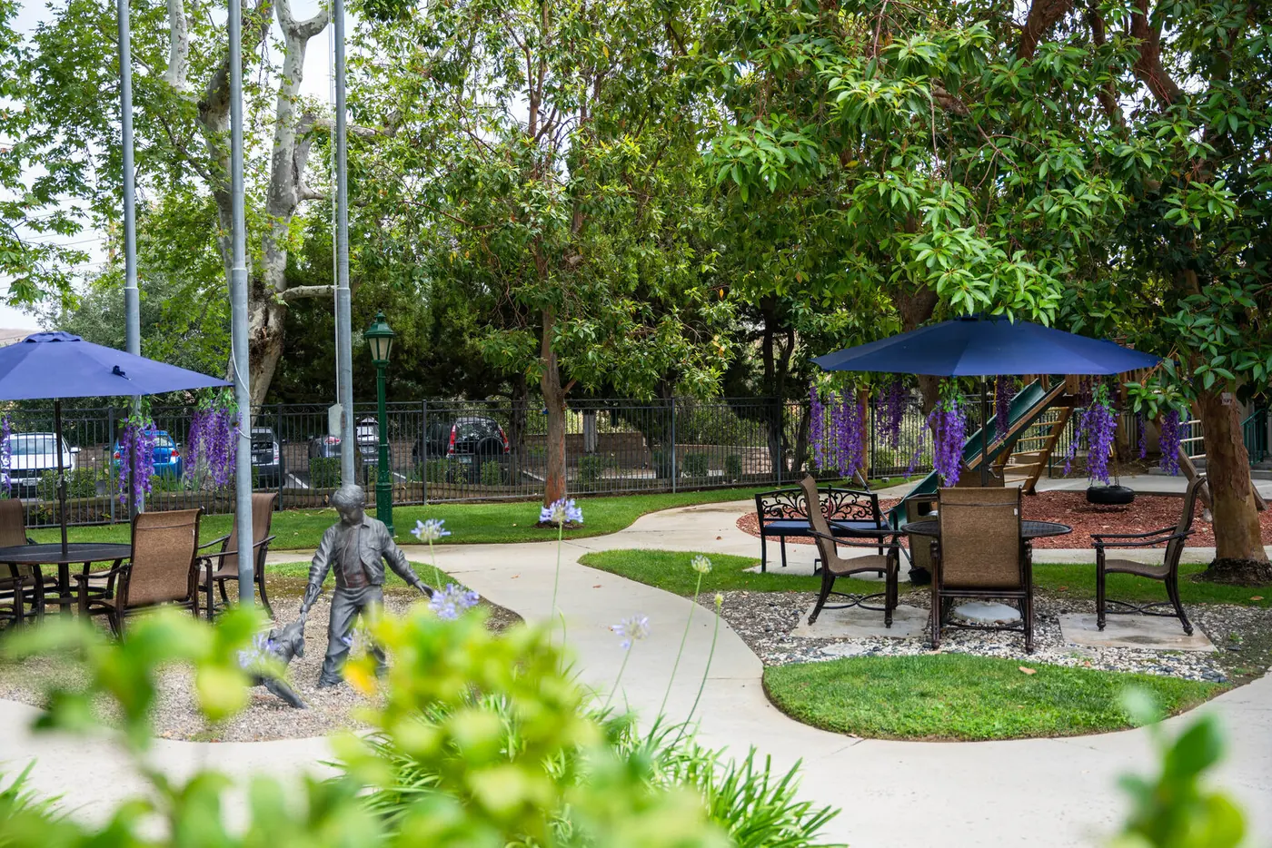 Shaded patio tables under mature trees