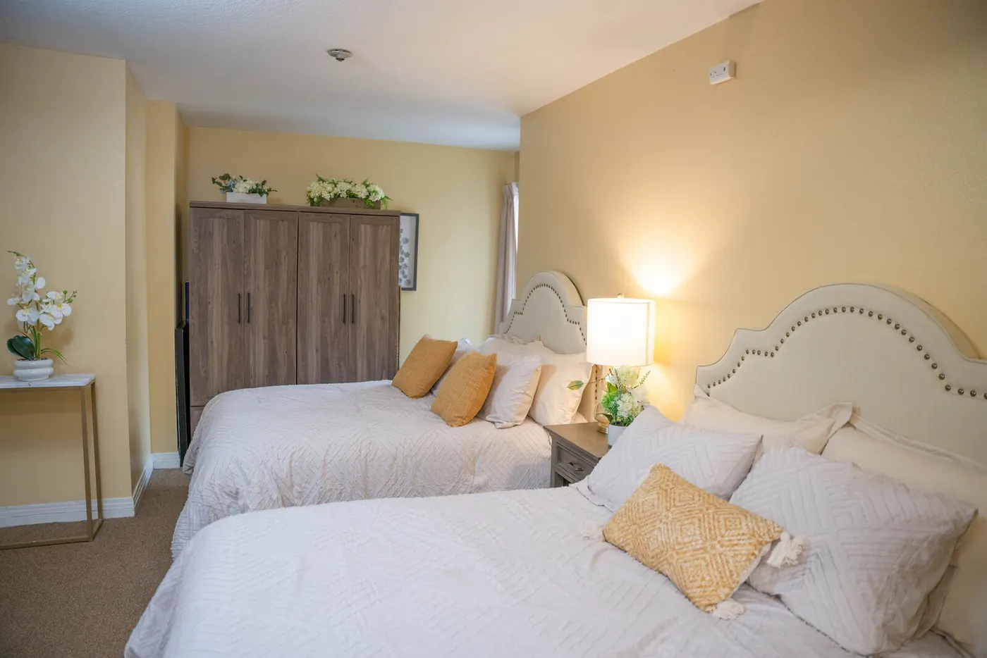 A resident bedroom with a wardrobe and reading lamp