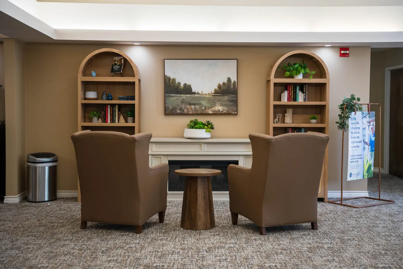 The library lounge, with armchairs and built-in bookshelves