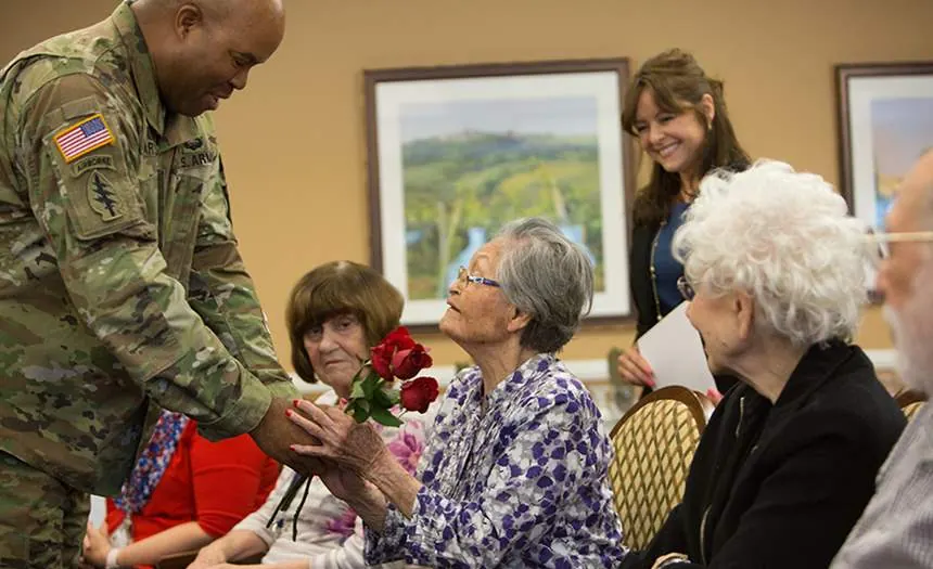 Roses presented to residents at a veterans ceremony