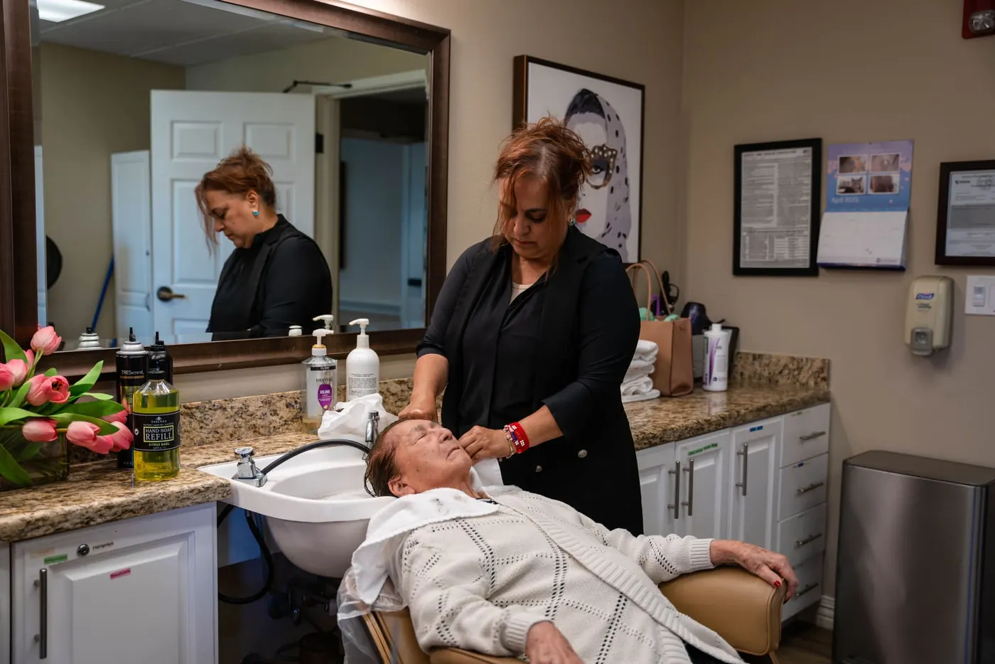 Residents being attended to at the salon wash basins