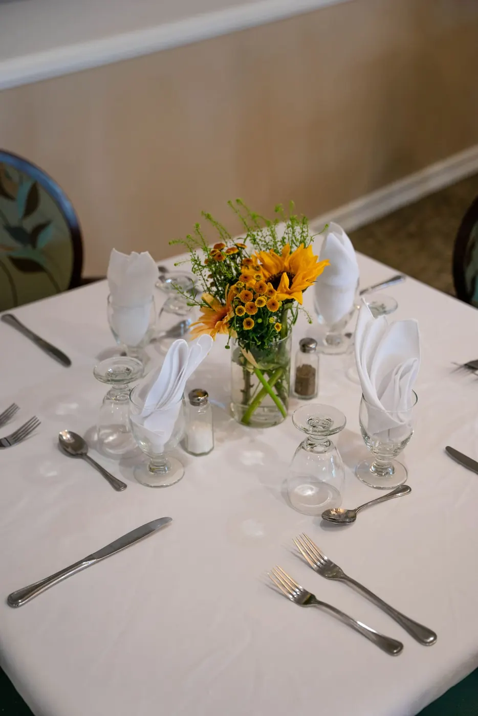 A dining table set with fresh flowers