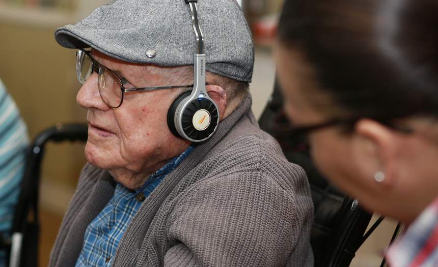 Elderly man using eversound headphone system