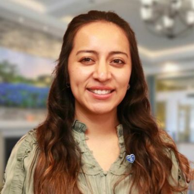 girl with brown wavy hair and button up
