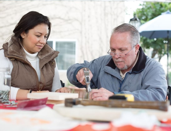 Resident doing woodworking activity