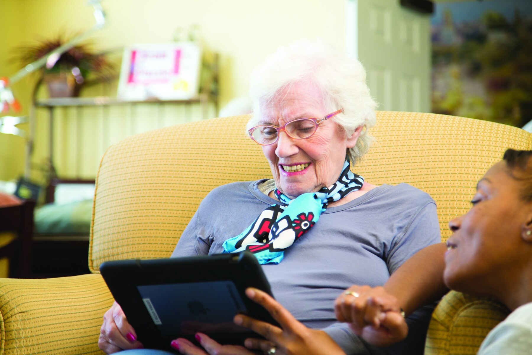 A Silverado resident and team member share a specialized digital activity