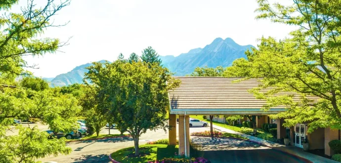 The entrance and Wasatch mountain view at Silverado Aspen Park memory care community in Salt Lake City, Utah