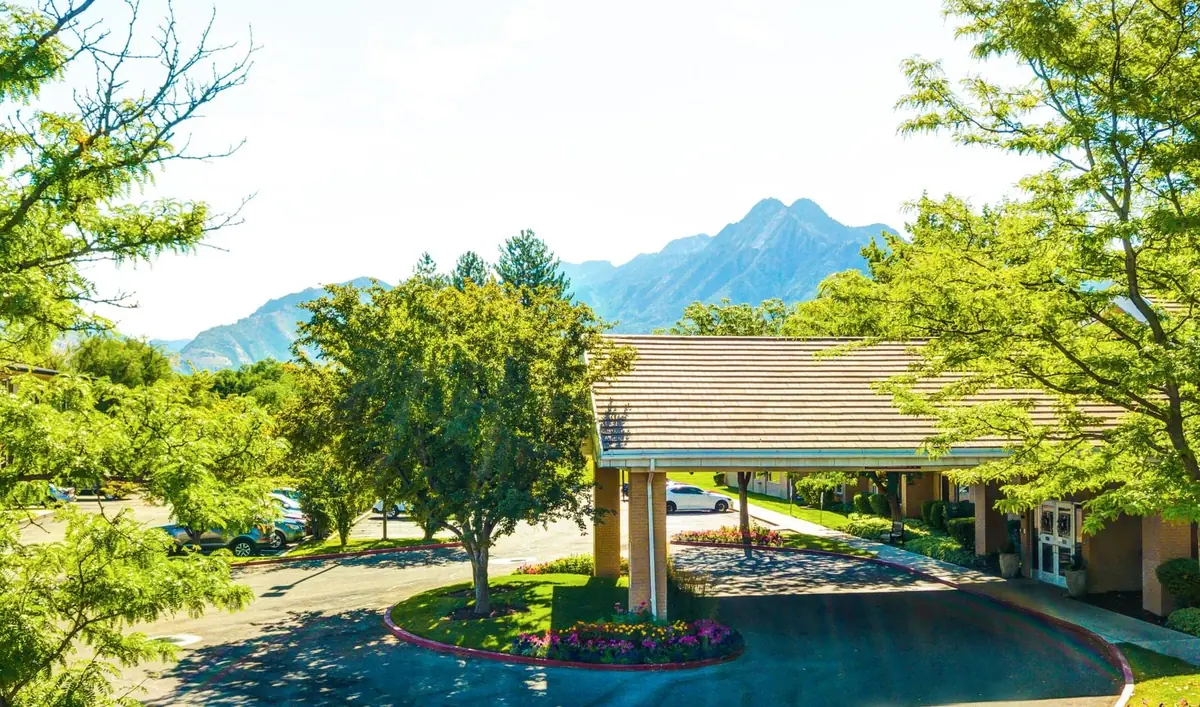 The entrance and Wasatch mountain view at Silverado Aspen Park memory care community in Salt Lake City, Utah